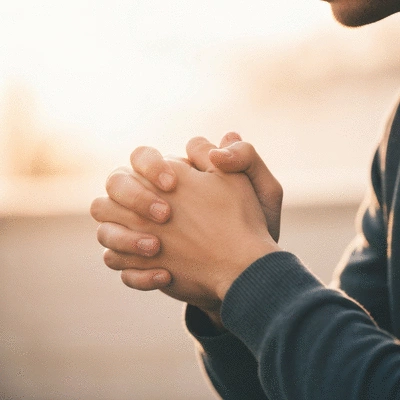 Hands clasped in prayer, symbolizing connection and faith
