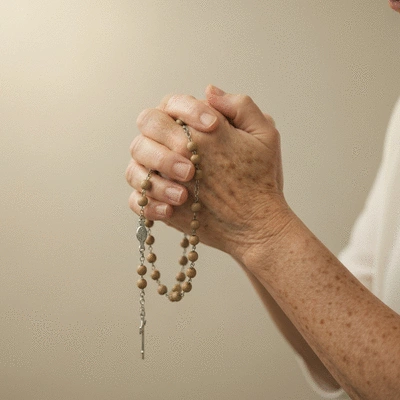 Hands holding a rosary during prayer, serene and peaceful atmosphere, no text, no words, no typography, clean image